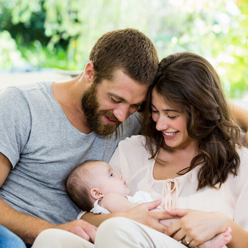 happy-parents-with-their-baby-in-living-room-VSXX89Yweb